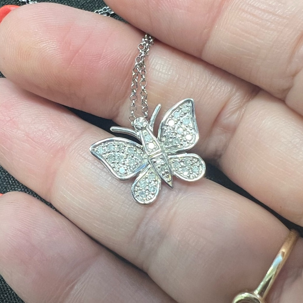 Silver and diamonds butterfly necklace.
